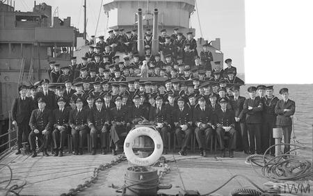 The crew of HMS Vivien at Sheerness in 1944.  AB Jack Taylor is sitting between the guns of the forward turret.  (c) IWM A 22070