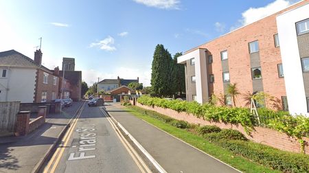 A modern view of Friars St with Williams Grange on the right and St Nicholas' Tower in the distance.