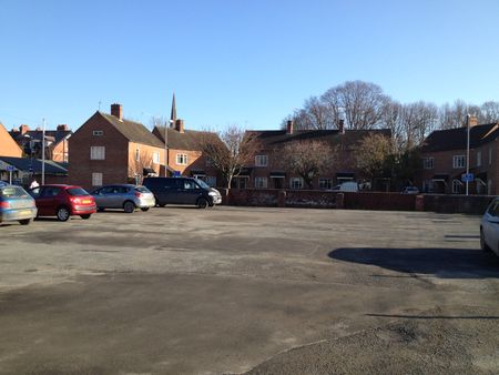 A modern view taken from The Military Club carpark - the admin buildings have gone and the houses in the picture are on the 'opposite' side of Friars St. All Saints Spire in the distance.