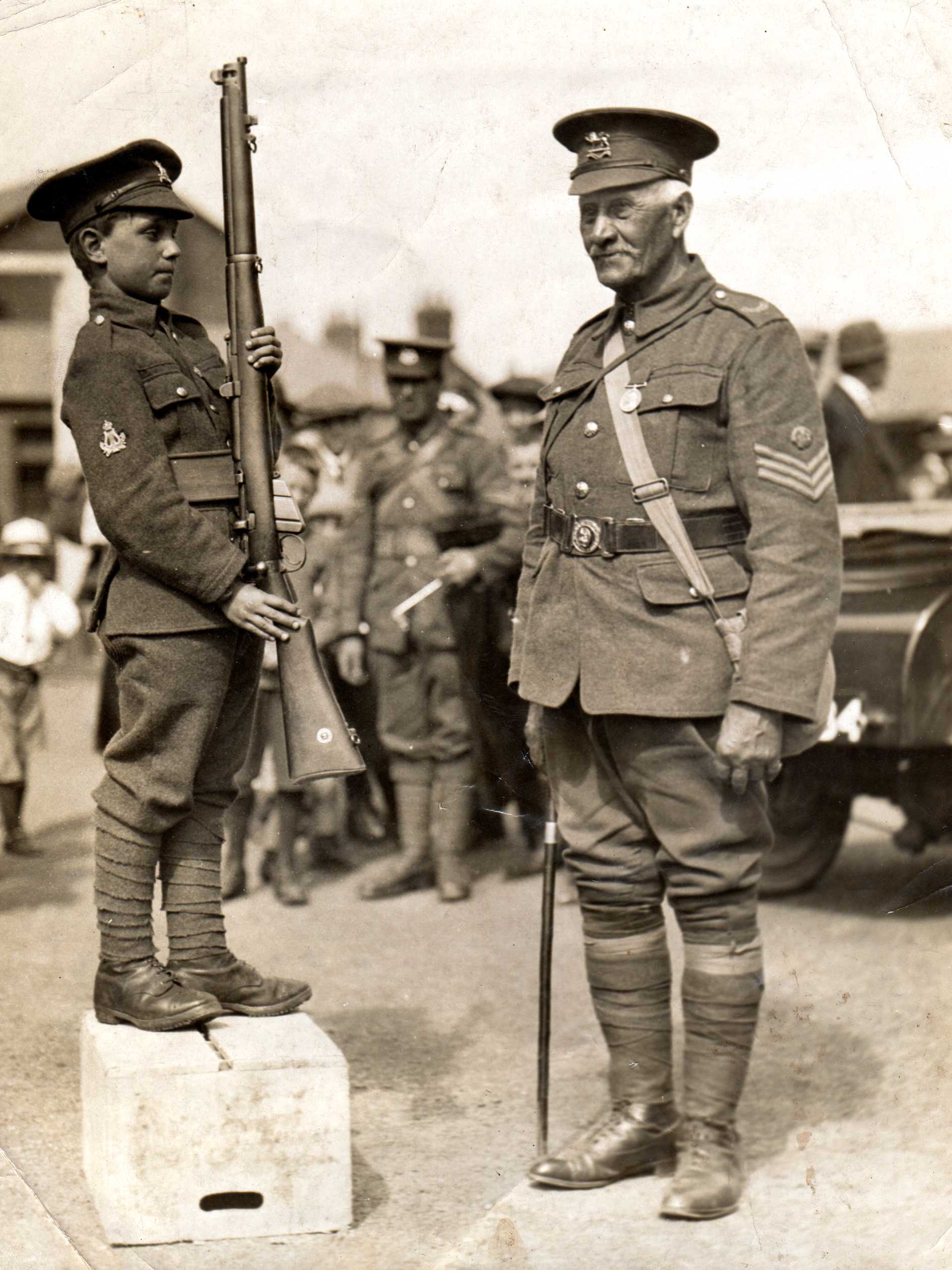 Colour Sergeant J Bethell, the oldest soldier in the Battalion (joined 1869) and Bandsman T Barber the youngest (aged 10) on return from annual camp at Porthcawl 1923.) 