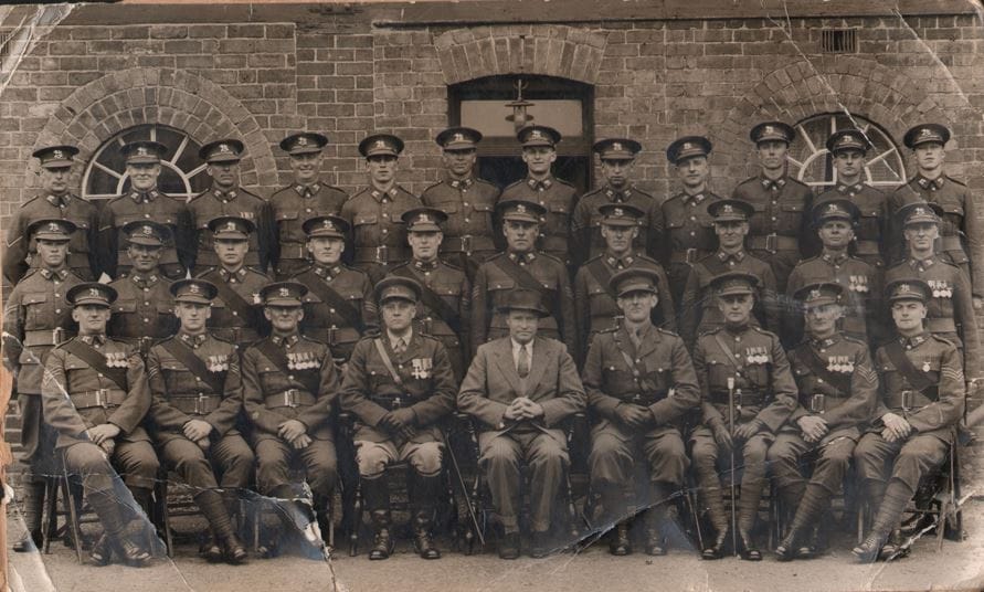 The Herefordshire Regiment's party that travelled to London for various duties in support of the 1937 Coronation of King George VII.. Sgt Cale is in the photo and is thought to be the man in the front row on the extreme right (as viewed).