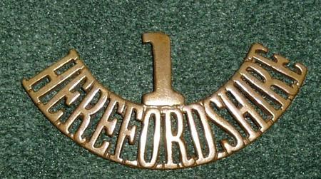 A Herefordshire Regiment shoulder title with the "T" filed into a "1" by order of the Commanding Officer in autumn 1914.